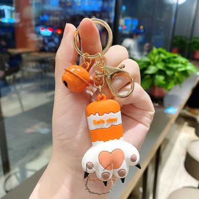 Keychain in the shape of a cat's paw with a bell - white-orange