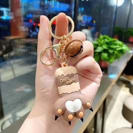 Keychain in the shape of a cat's paw with a bell - brown